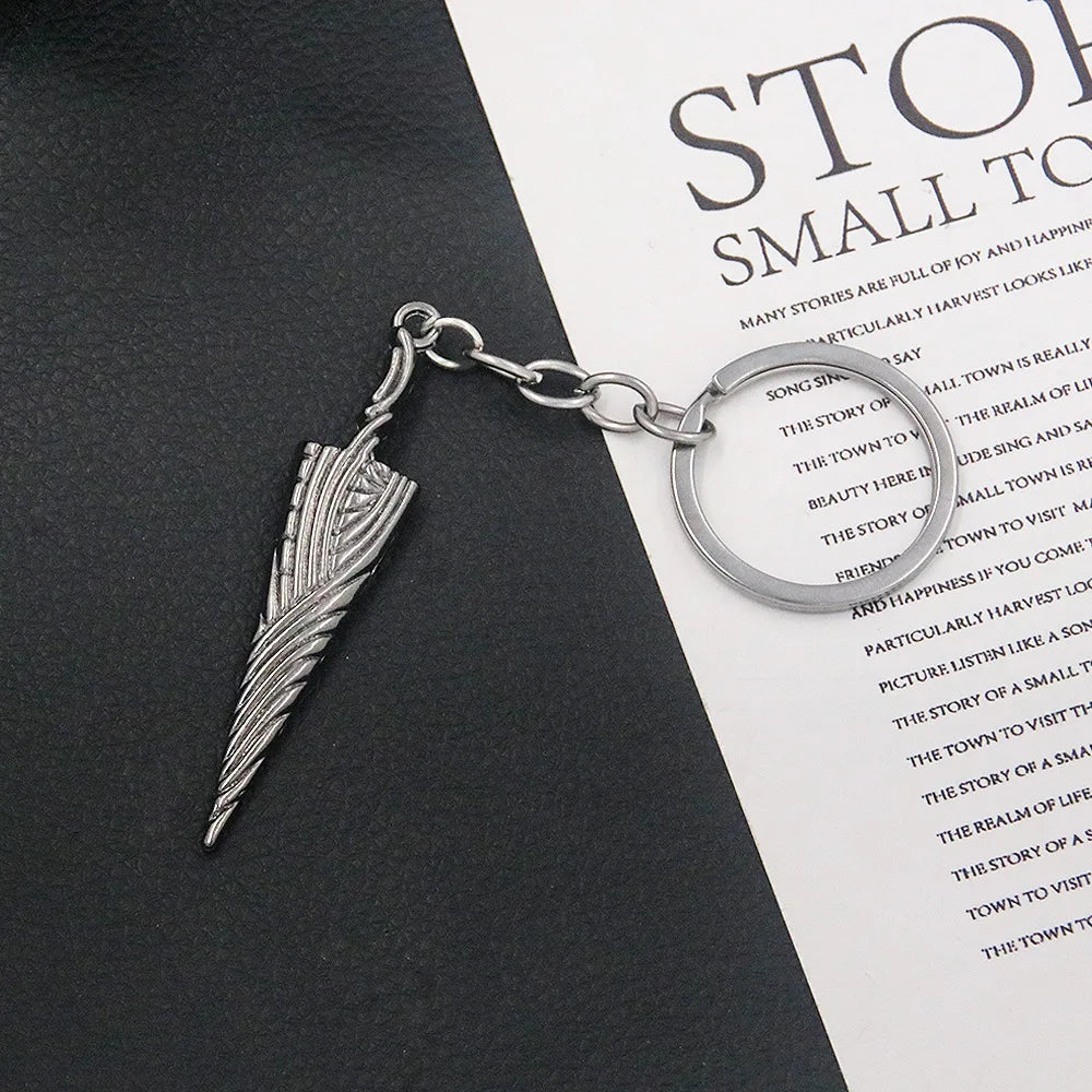 Detailed view of the Hollow Knight Nail Sword keychain, showing intricate metal pendant craftsmanship