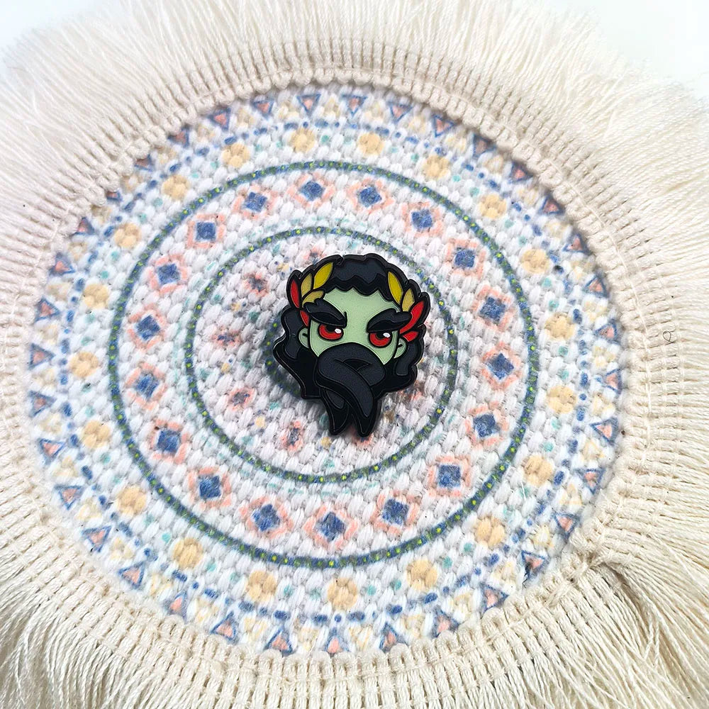 A detailed close-up of the Hypnos Hades pin design, highlighting the metal and enamel quality