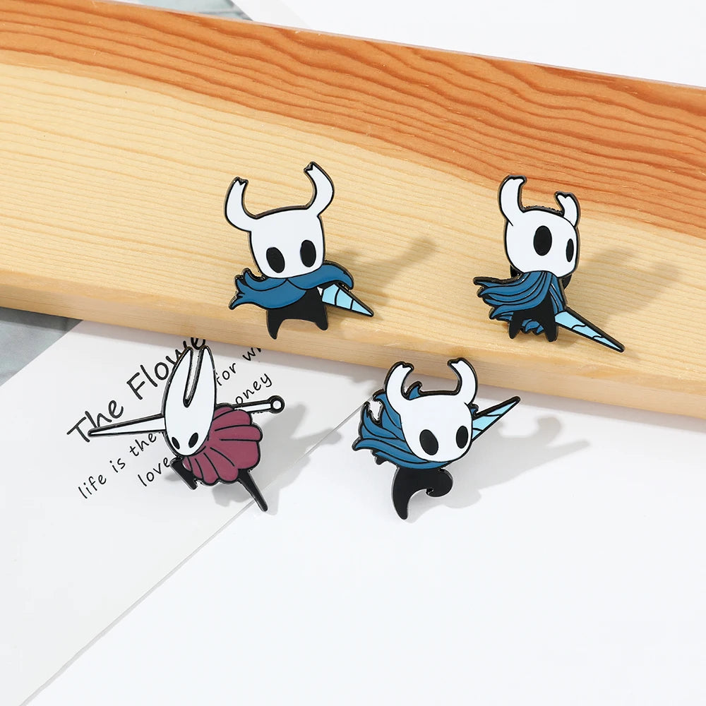 Cute Hollow Knight enamel pin on a table