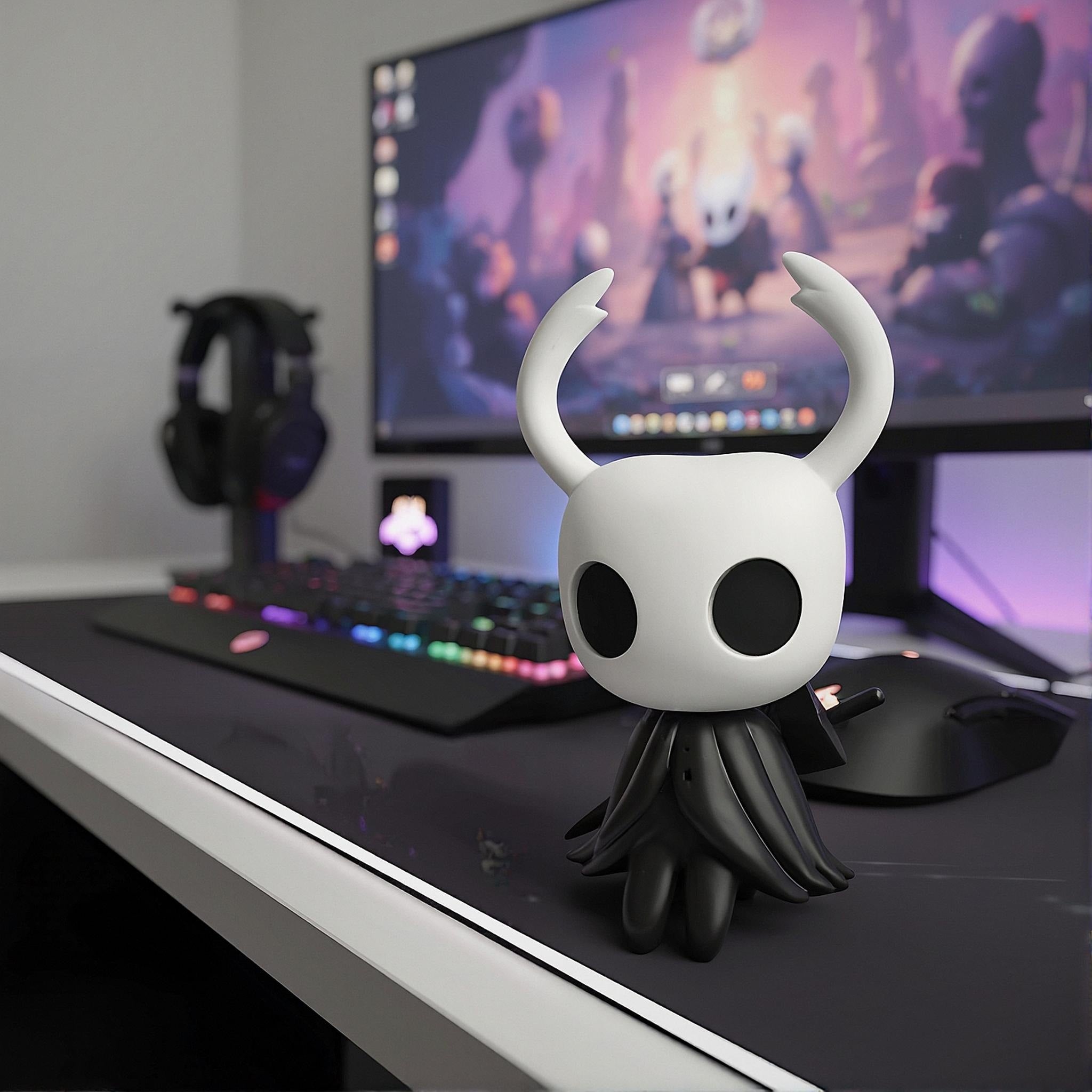 Hollow Knight Mini Figure of The Knight displayed next to a computer monitor, showing its small scale for PC case decor.