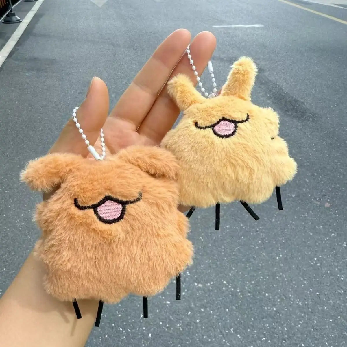 Front view of the Squeaky Silksong Flea Plush Keychain and Backpack Charm, highlighting the soft material.