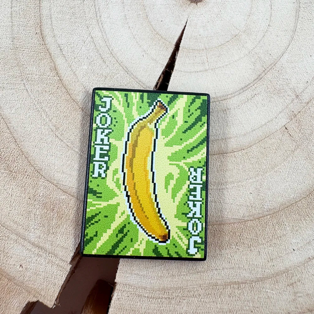 balatro banana joker enamel pin on a textured surface