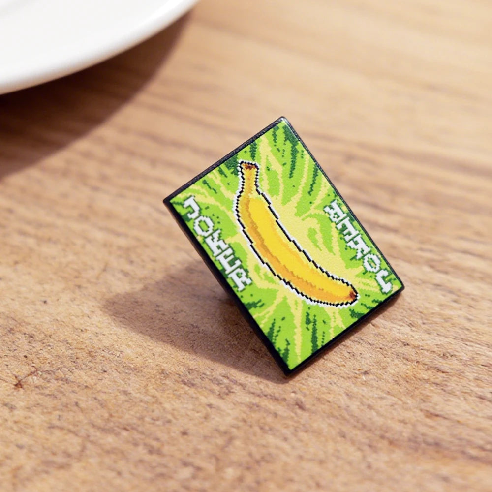 Side view of the Banana Joker Enamel Pin, featuring the smiling Gros Michel design.