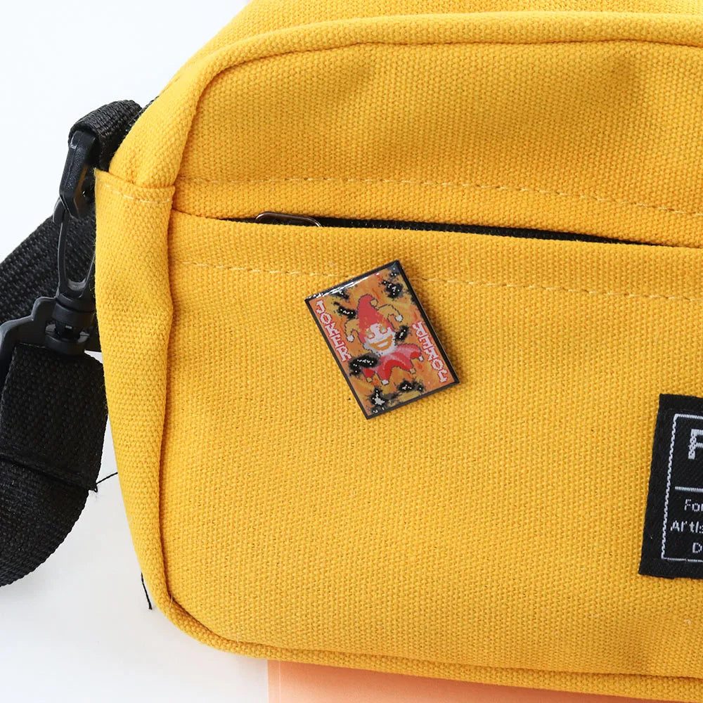 Yellow bag with a patch featuring a Burnt Joker Balatro design on a white background