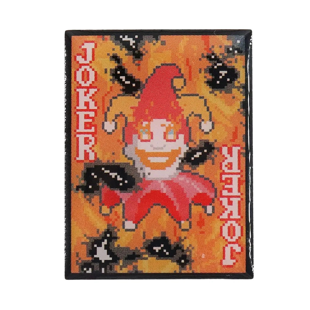 Front view of the Burnt Joker Enamel Pin, featuring the charred pixel art design from the Balatro video game.