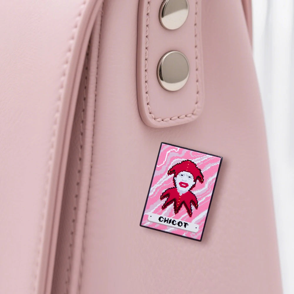 Pink bag with a pixelated character patch labeled 'Chicot Joker'