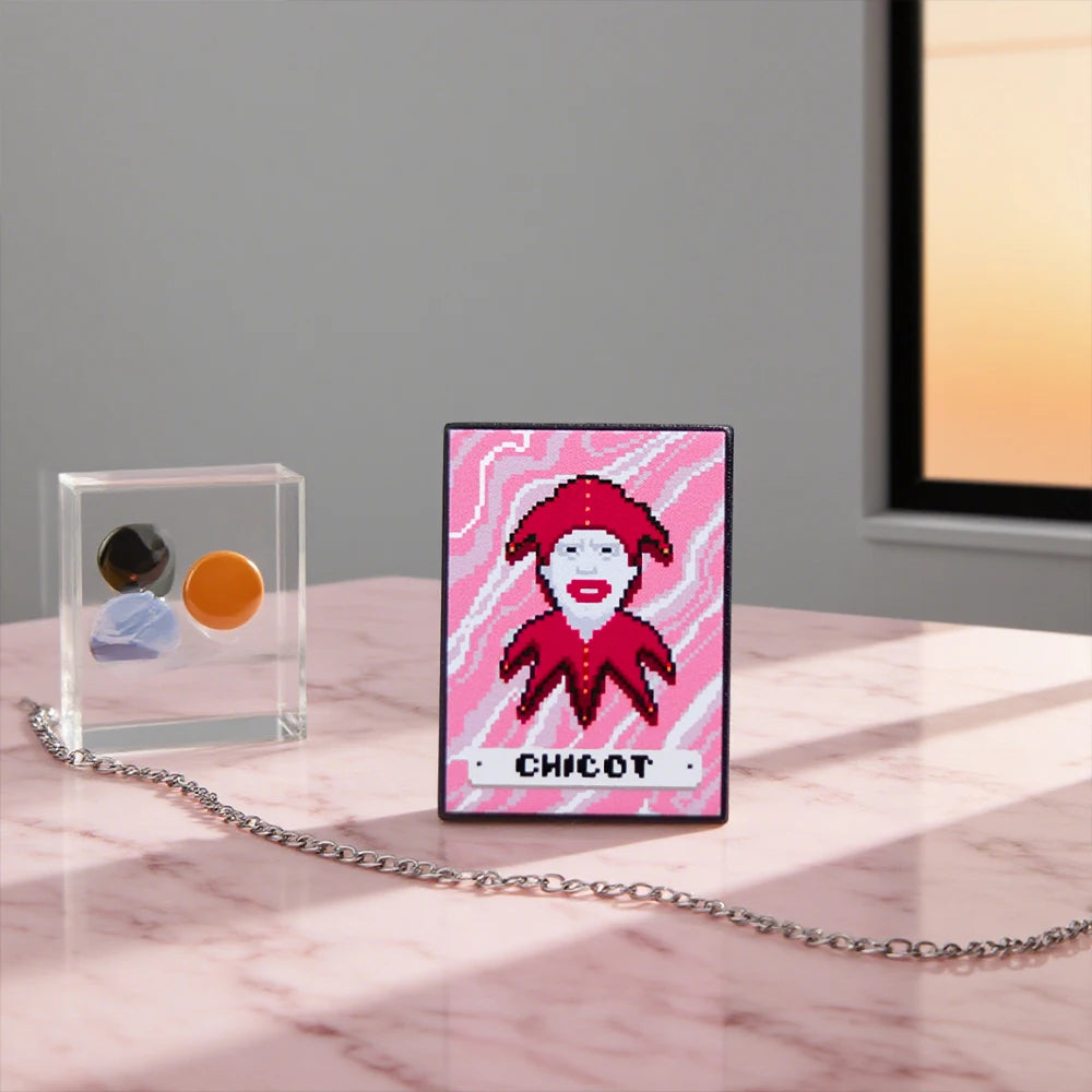 Pink card with a Chicot Joker design and 'Chicot' text on a marble surface.