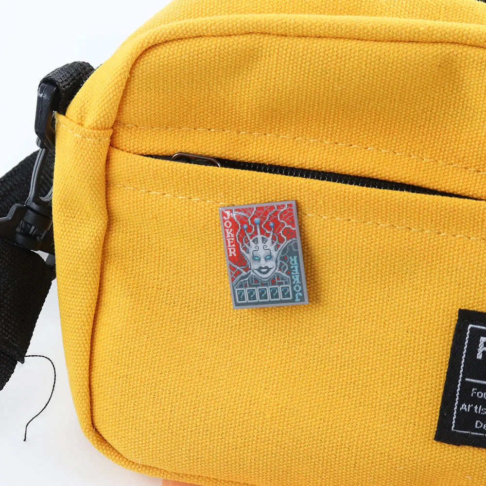he Chaos Theory Joker pin displayed on a backpack, showcasing it as a rare piece of Balatro fan merch.