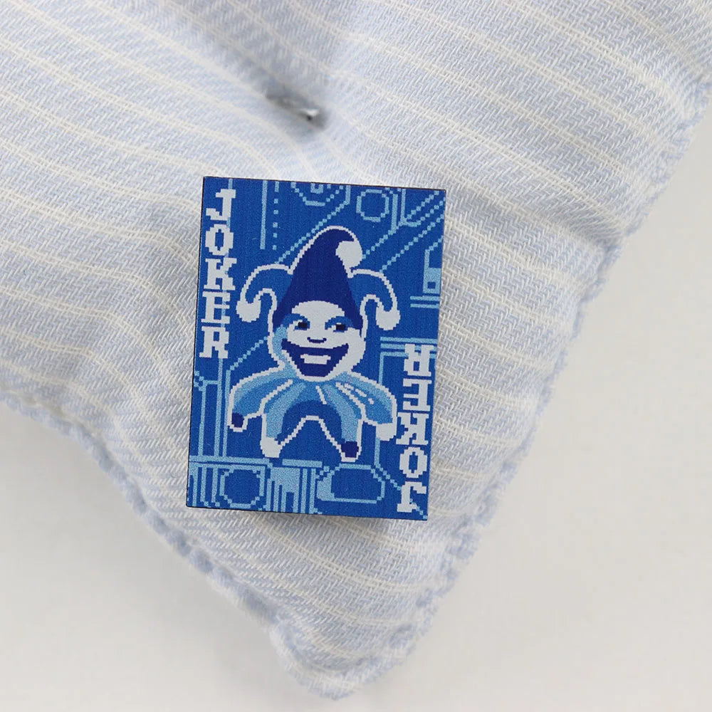Blue and white striped fabric with a 'Blueprint Joker' Pin on a light gray background