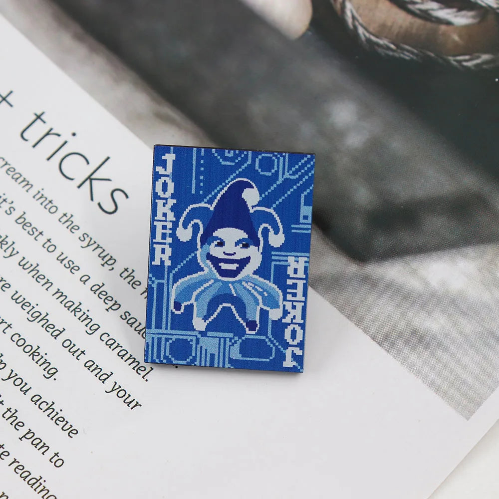 Blue and white brooches with 'Blueprint Joker' design on a magazine page