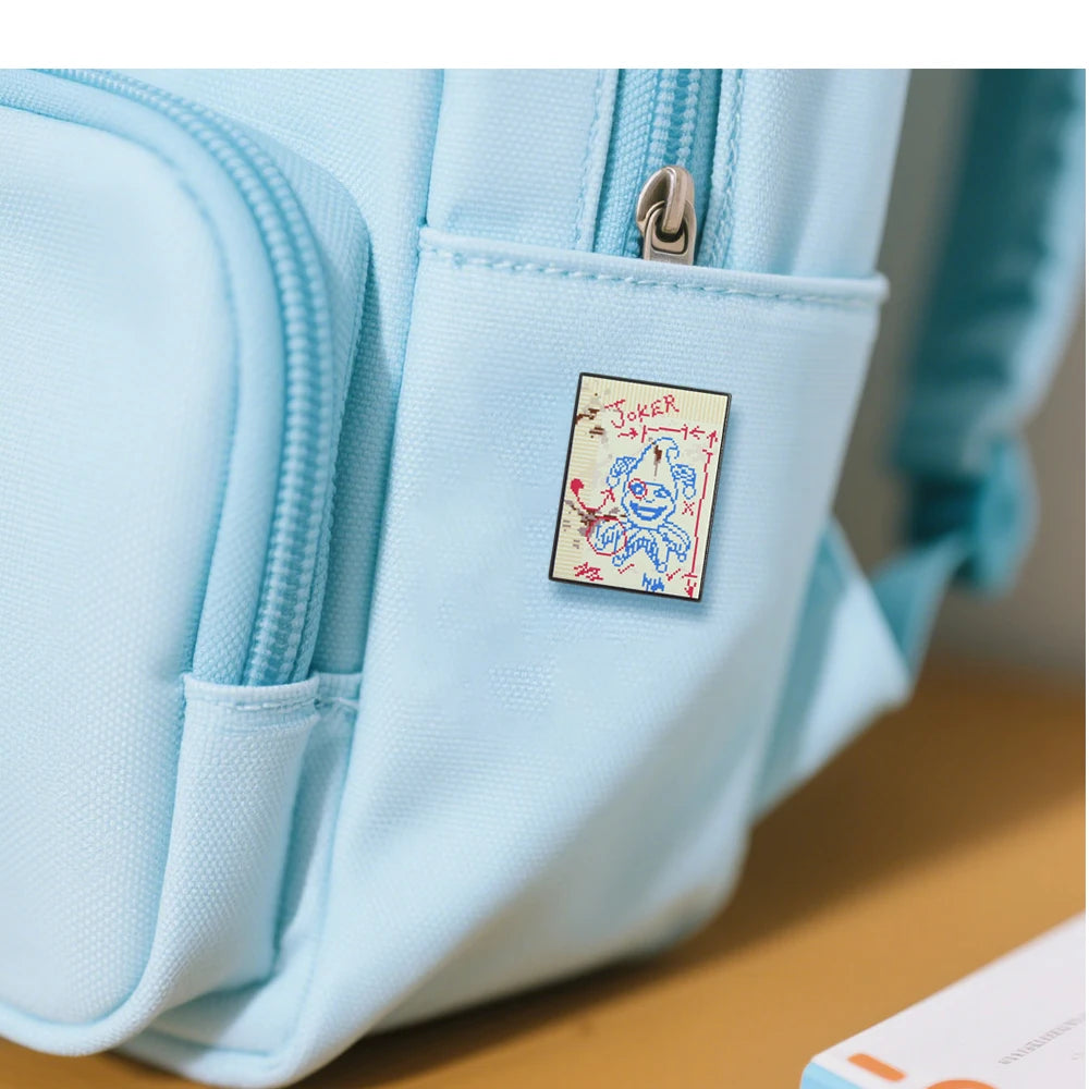 The Brainstorm Joker pin displayed on a gamer's backpack, perfect for Balatro video game fans.