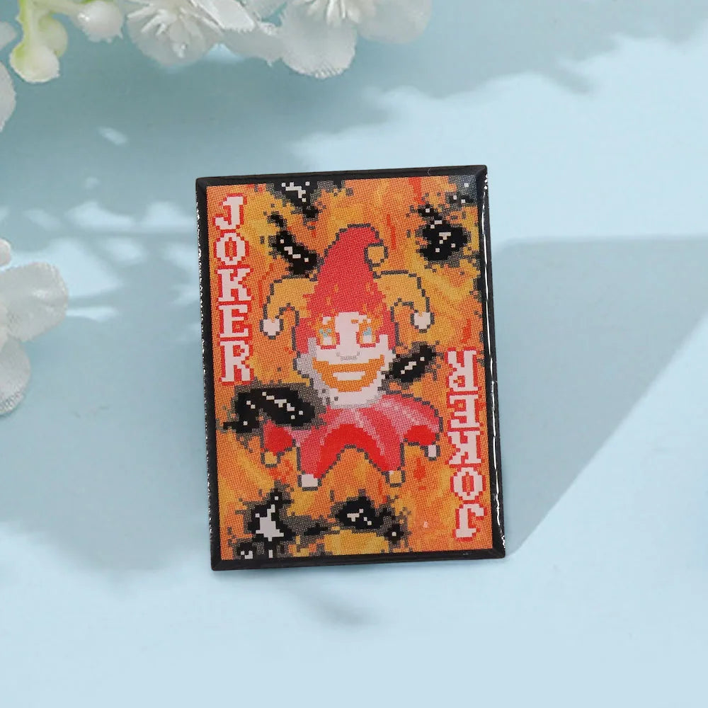 The Burnt Joker pin displayed on a gaming desk, perfect for Balatro video game fans.