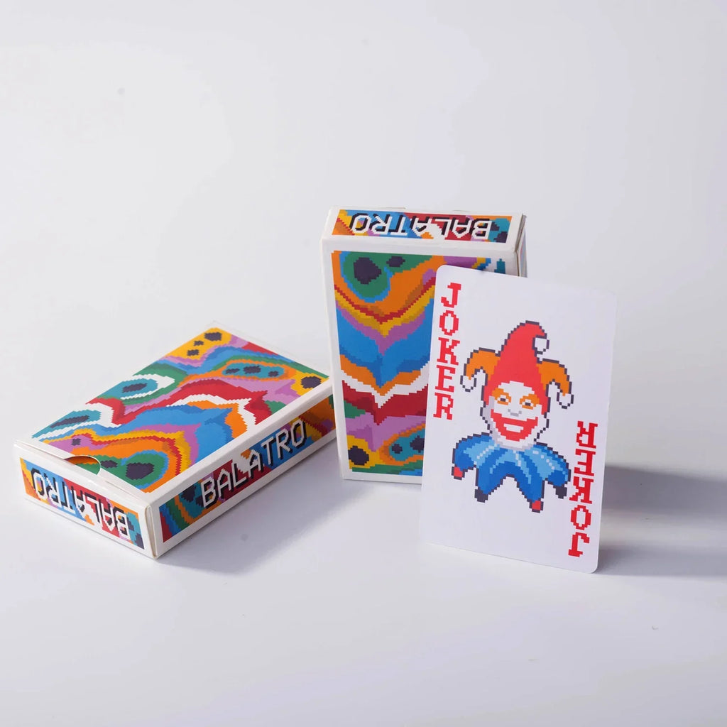 The themed tuck box for the Balatro card deck, sitting on a gaming table.