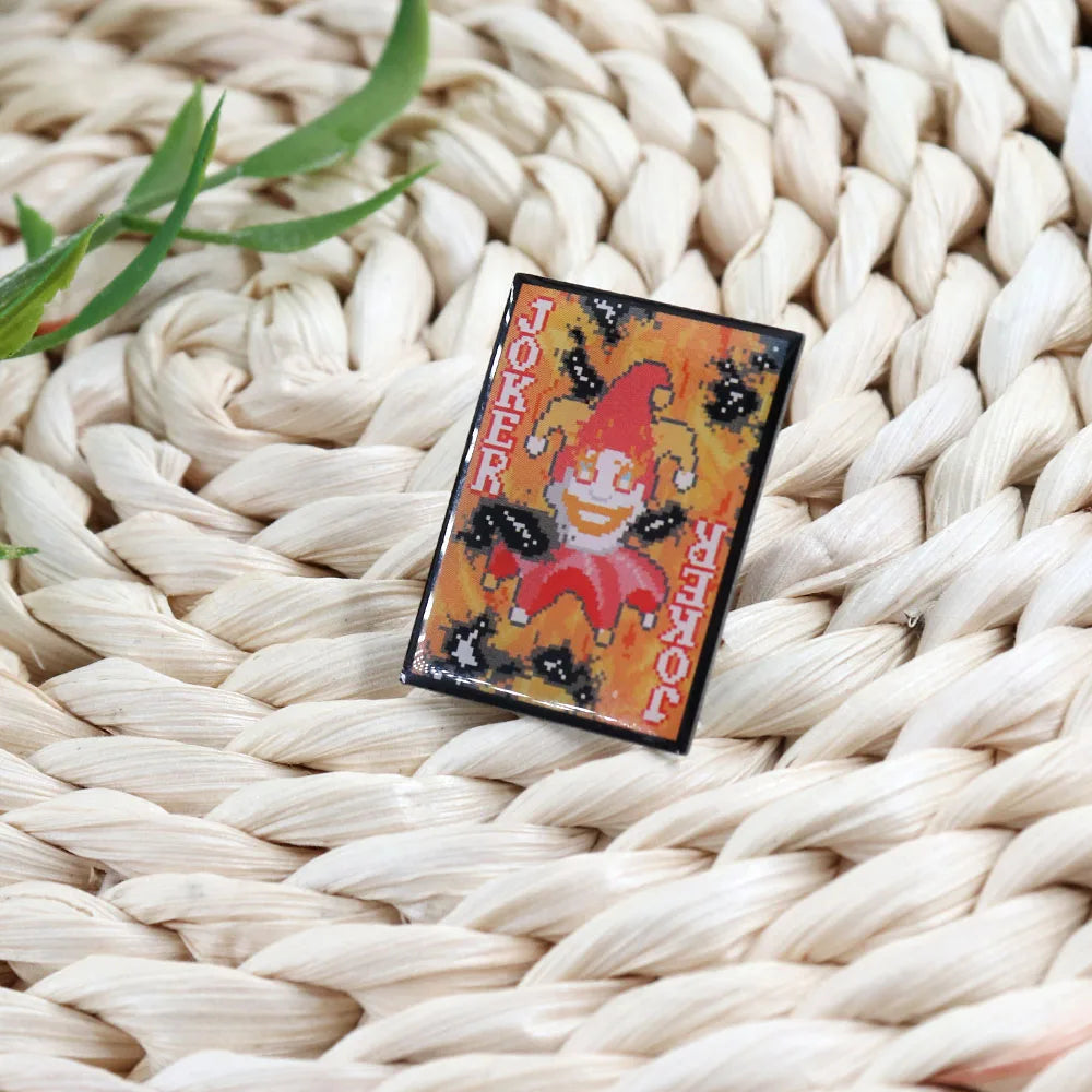 Close-up of the Burnt Joker pin showing the dark metal plating and detailed hard enamel "burnt" textures.