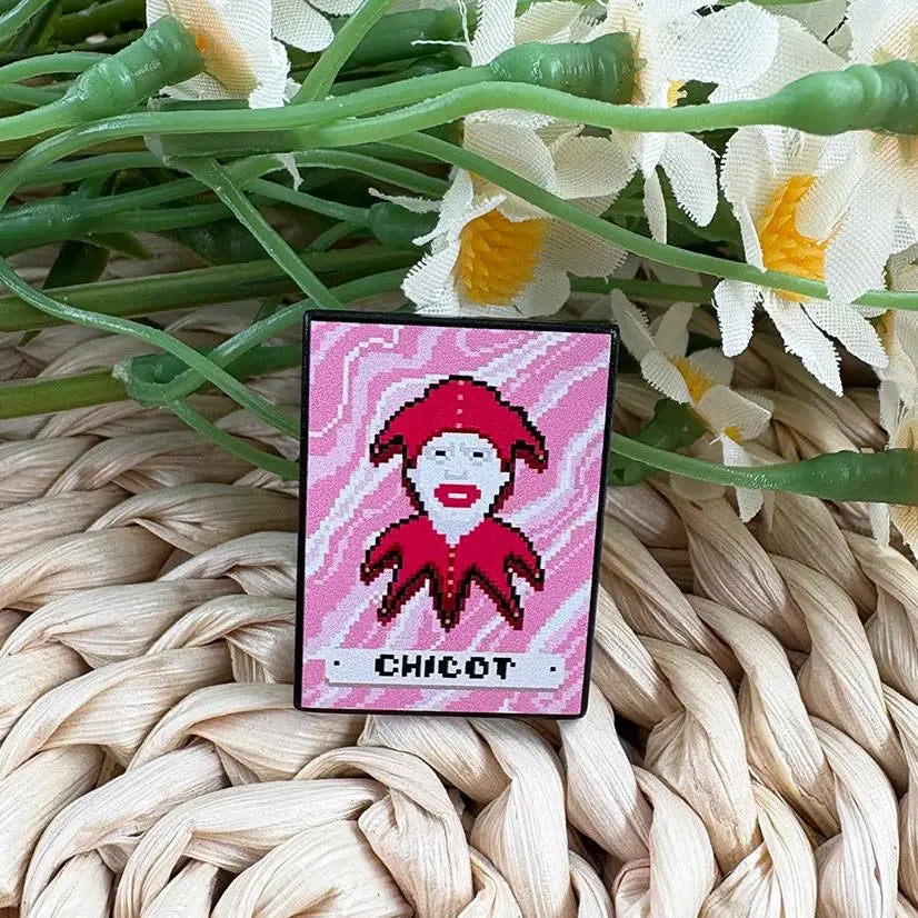 Close-up of the silver-tone plating and hard enamel finish on the Chicot Joker fan merch pin.