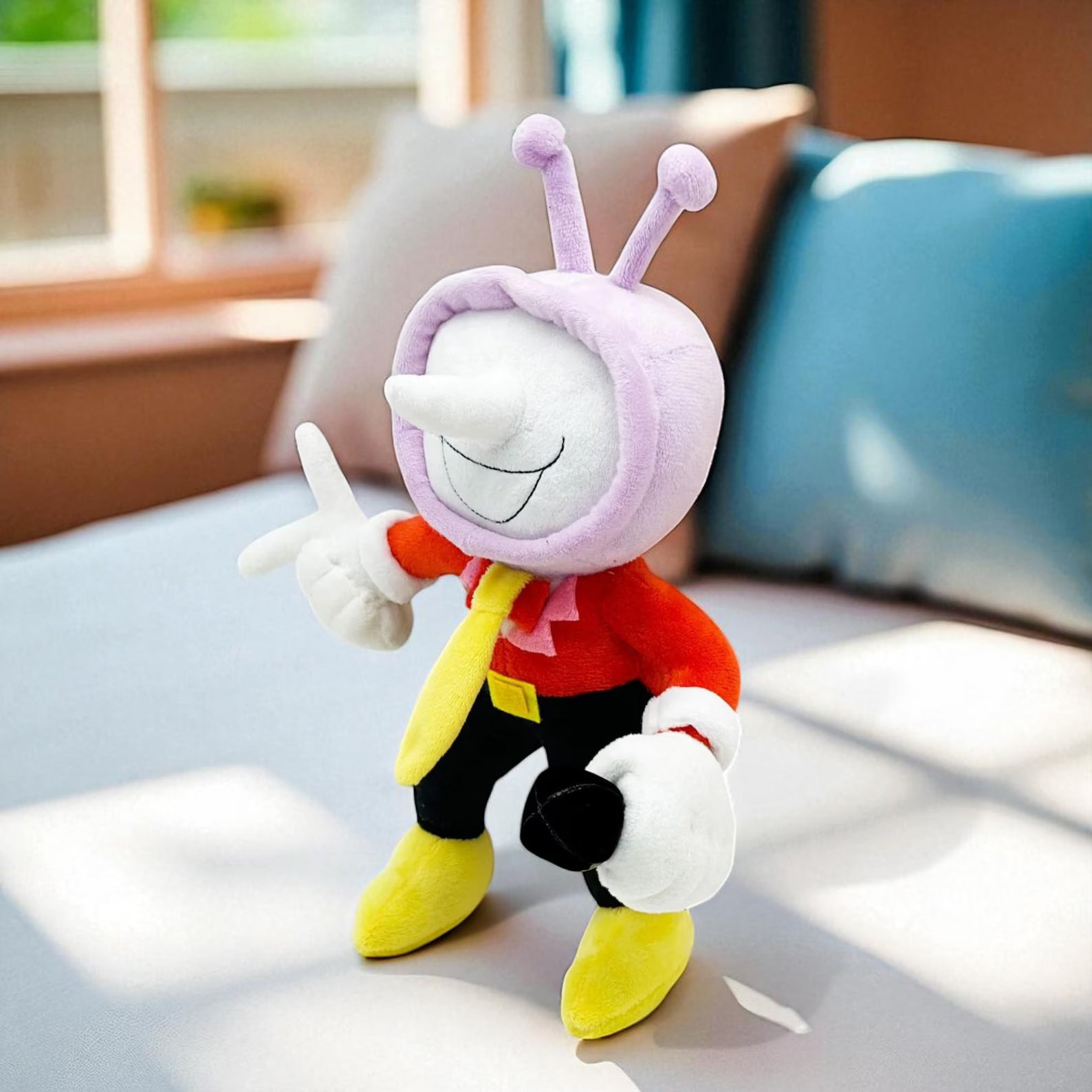 Close-up of the DELTARUNE Tenna Plush's face, focusing on the embroidered features and unique screen design
