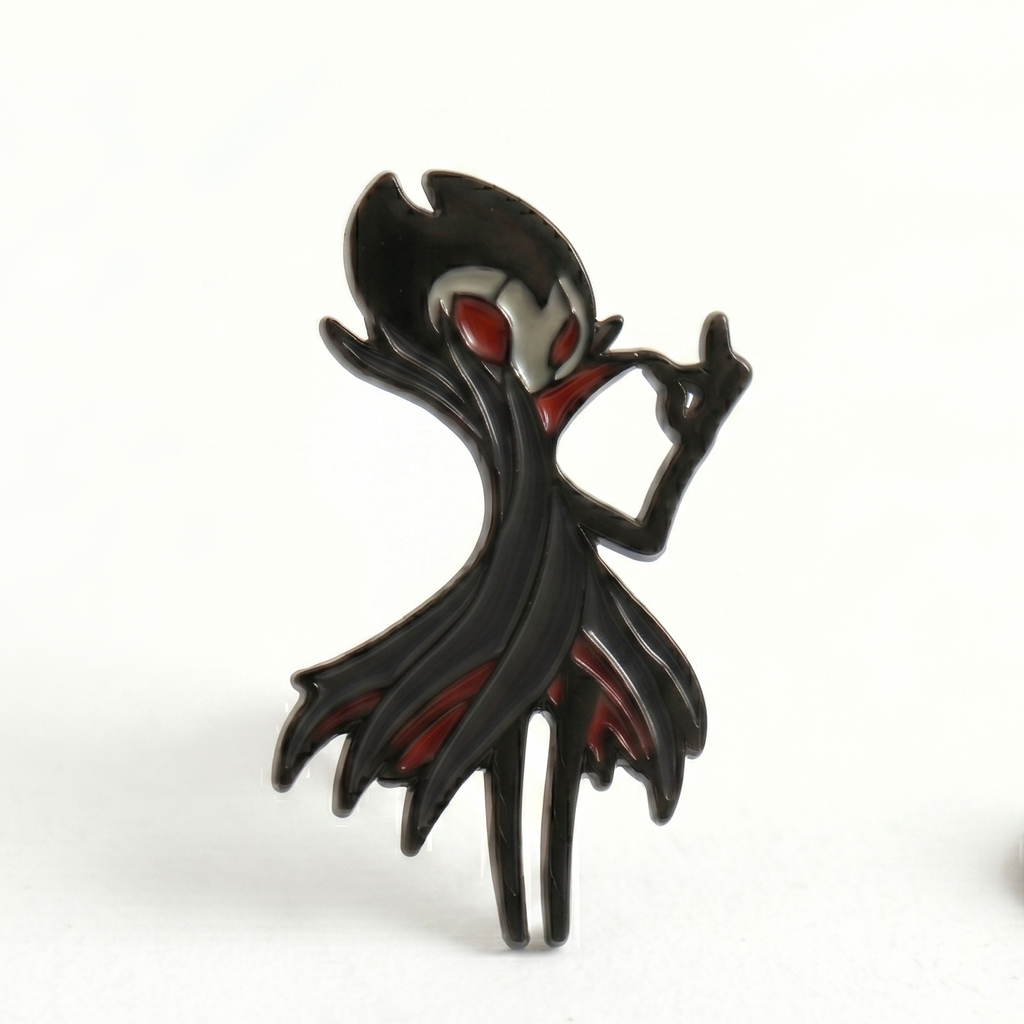 Detailed close-up of the red and black enamel pin on the Hollow Knight Grimm accessory.