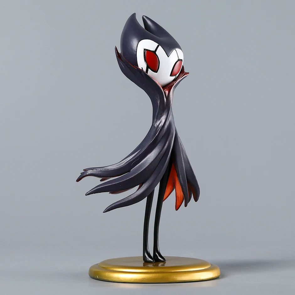 The Grimm Figure displayed on a gaming desk, commanding attention as a unique piece of Hollow Knight Merch.