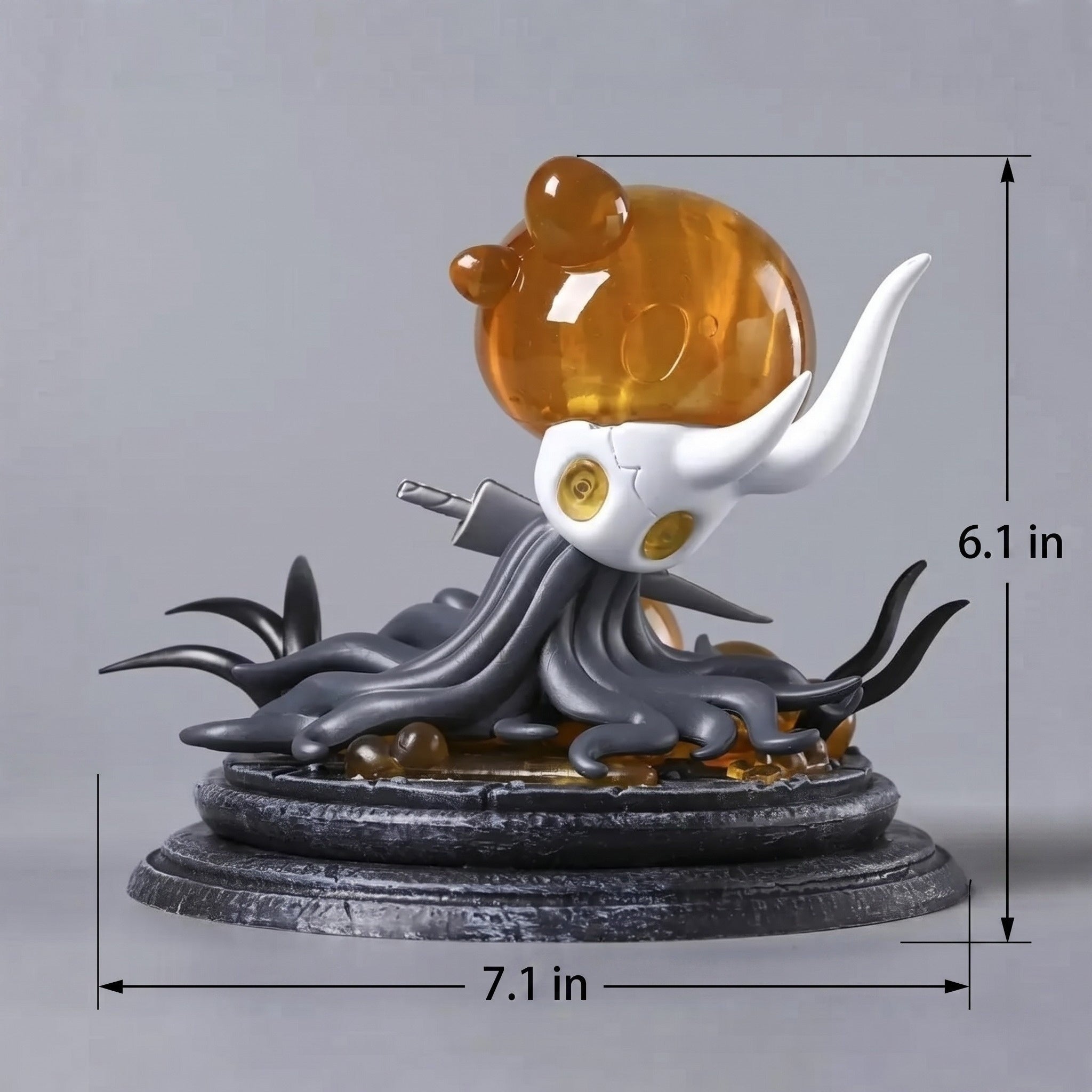 Side view displaying the 18cm x 15.5cm scale of the Hollow Knight Broken Vessel Figure on a gaming setup.