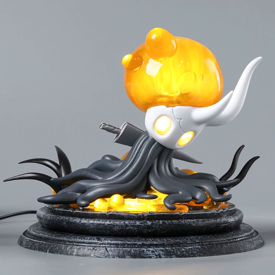 Front view of the Hollow Knight Broken Vessel Figure showing the infected orange light and cracked shell, premium Hollow Knight Merch.