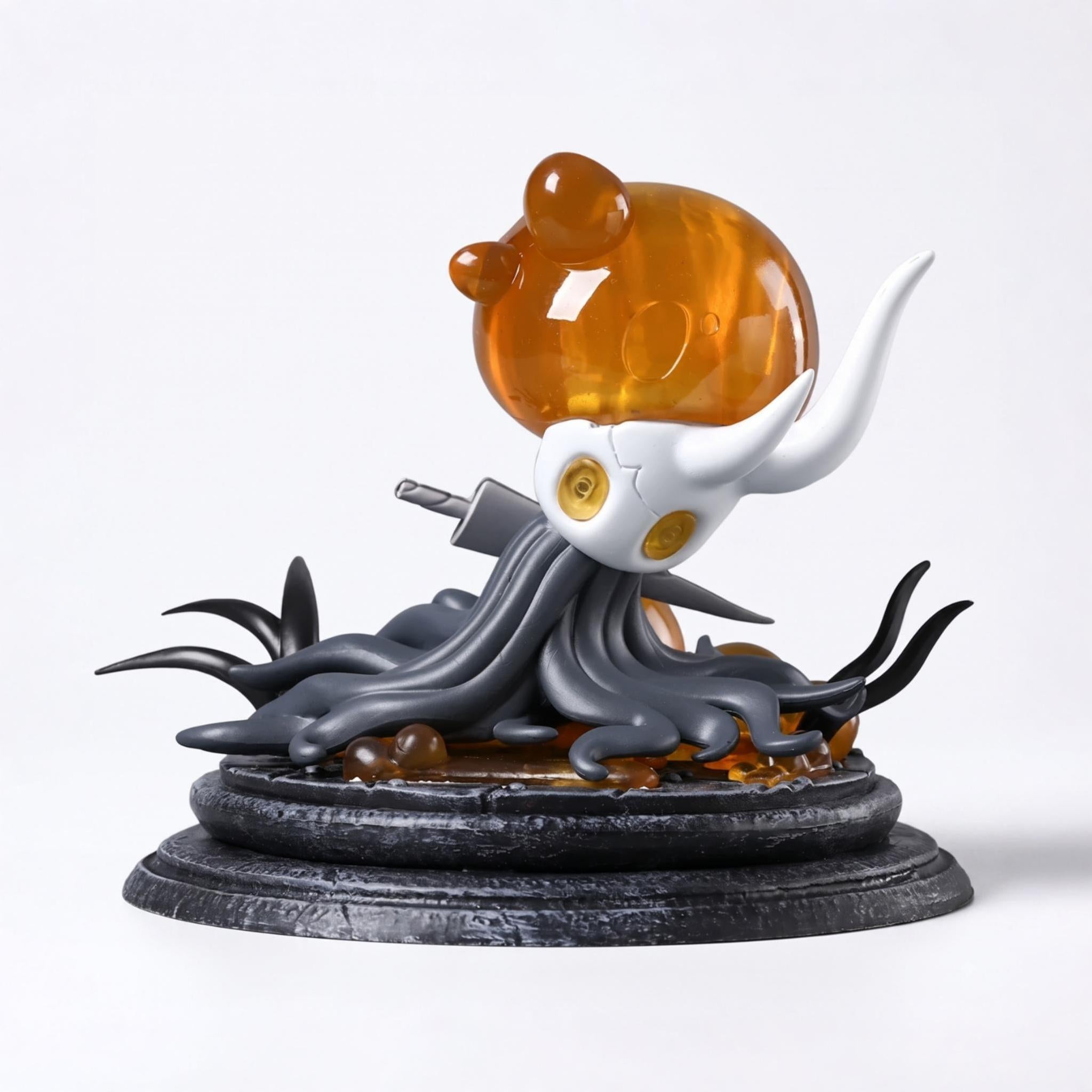 Front view of the Hollow Knight Broken Vessel Figure showing the infected orange light and cracked shell, premium Hollow Knight Merch.