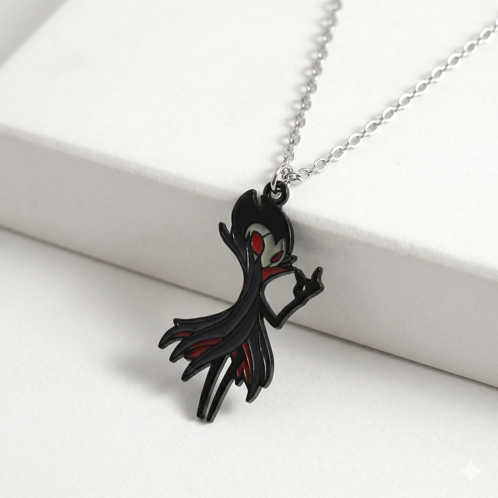 Detailed close-up of the red and black enamel on the Hollow Knight Grimm keychain, necklace accessory.