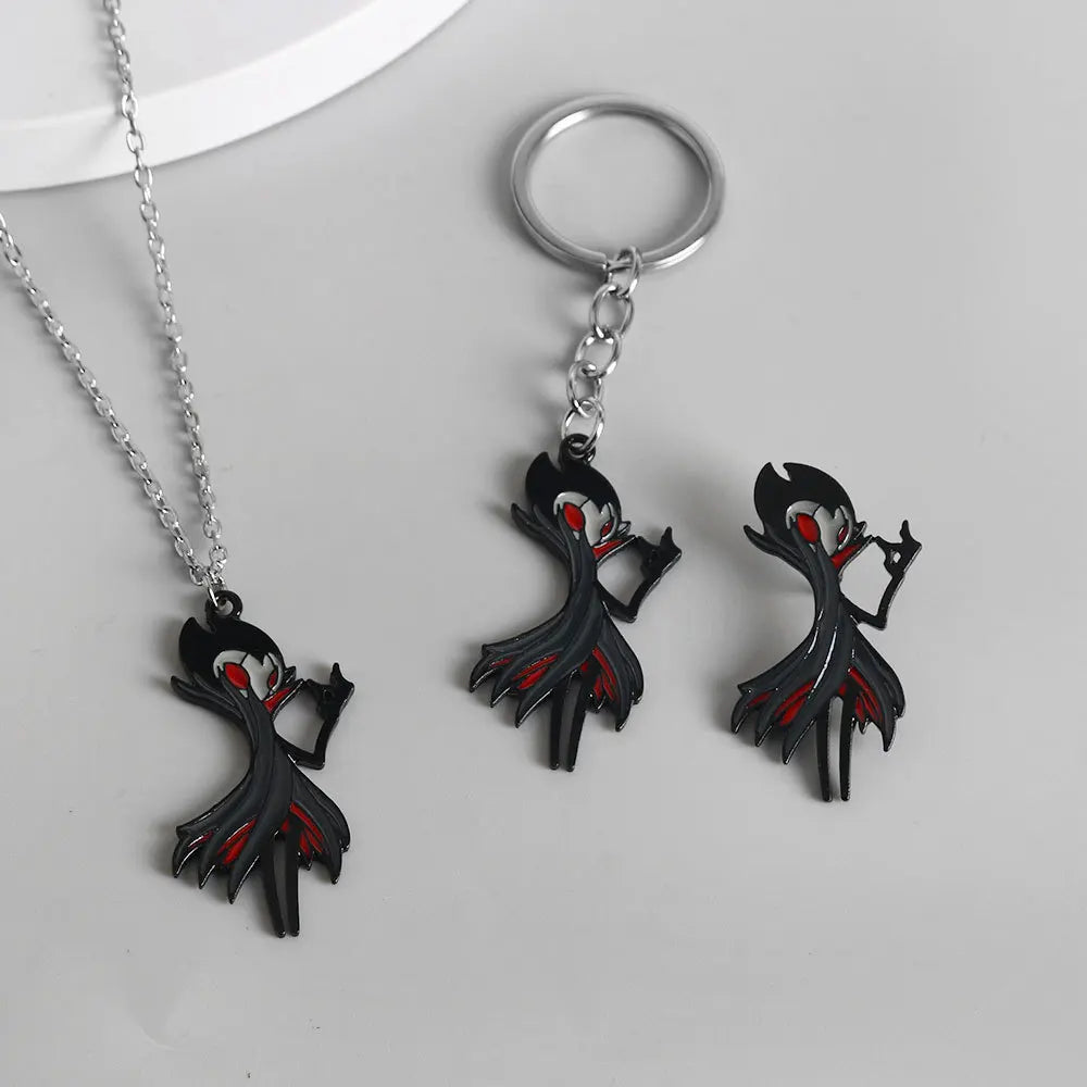 Close-up showing the Hollow Knight Grimm keychain attached to keys and the optional necklace chain.