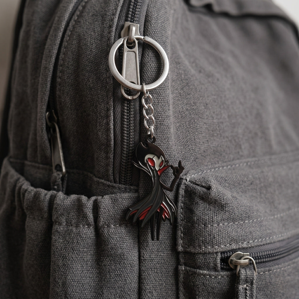 The Grimm keychain and necklace attached on a backpack, perfect fan-inspired Hollow Knight Merch.