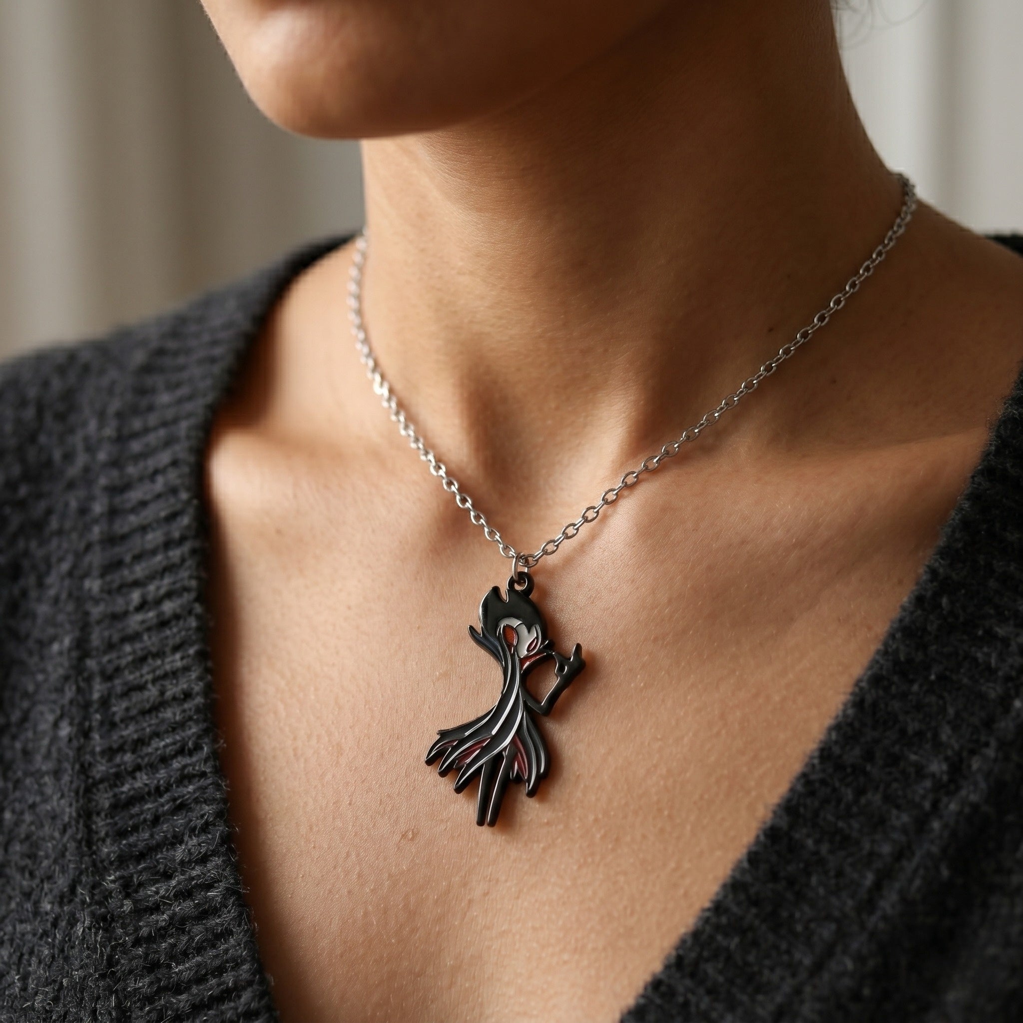 The Grimm necklace is wearing by a fan, perfect fan-inspired Hollow Knight Merch.