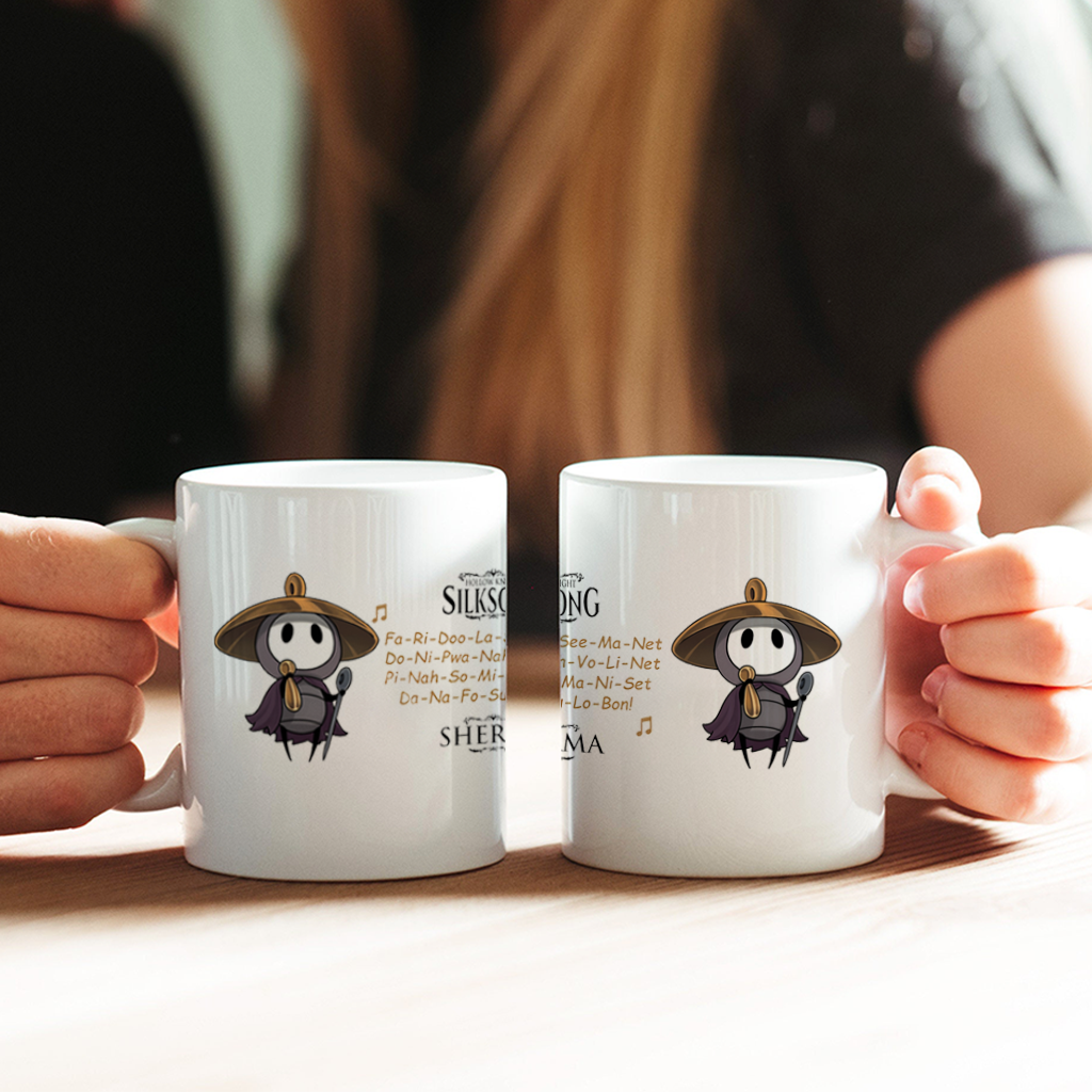 Hand holding the Sherma Hollow Knight mug by the wide C-handle to demonstrate comfortable grip and size