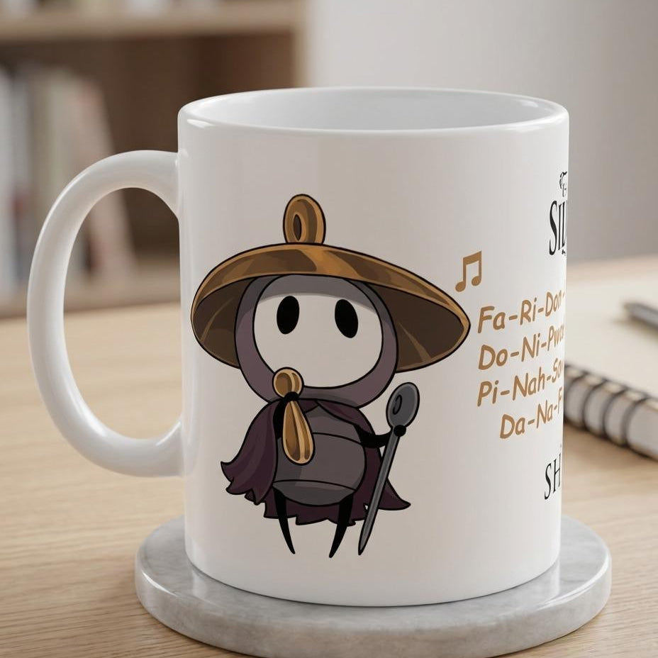 A white ceramic coffee mug with a Sherma from Silksong wearing a brown hat and dark cape, sitting on a round gray coaster on a wooden table.