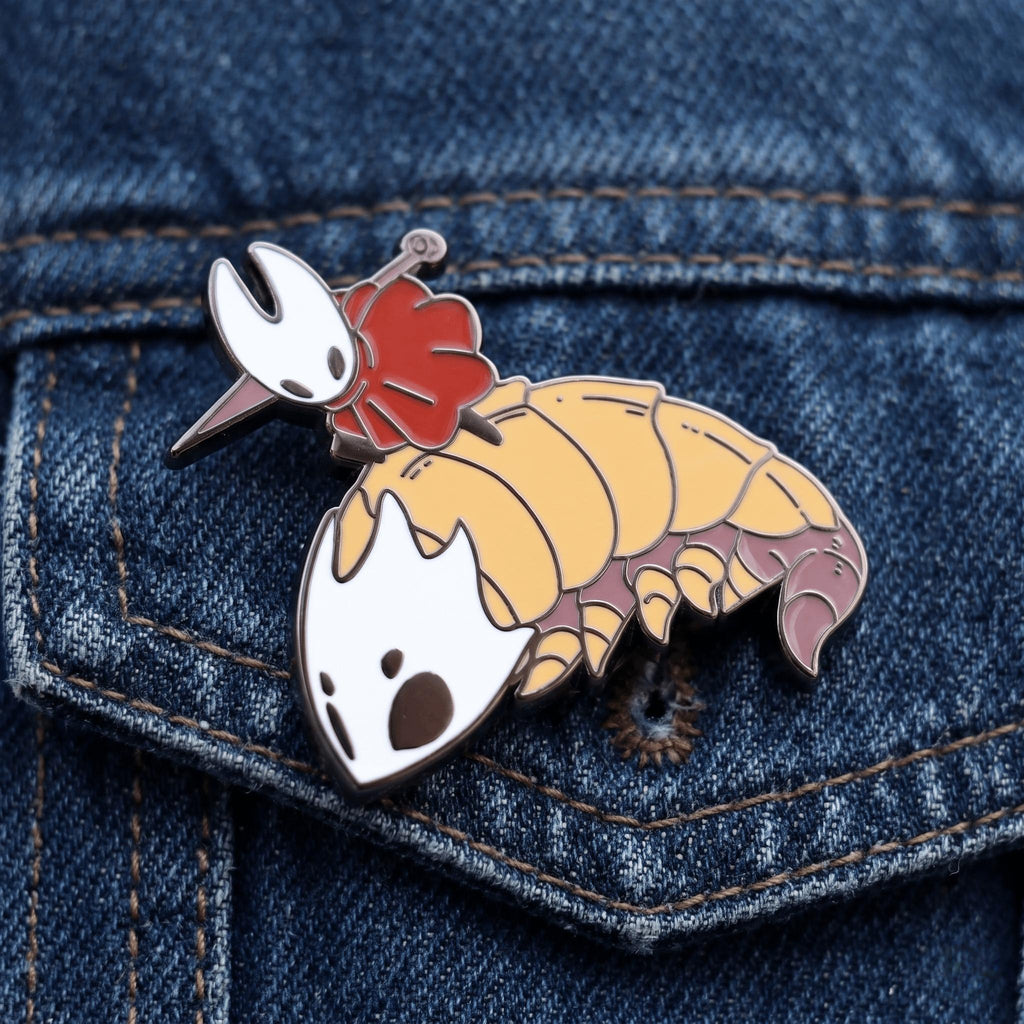 The Hornet & Bell Beast enamel pin attached to a canvas backpack, showcasing its 1.2 inch size and Silksong fan appeal.