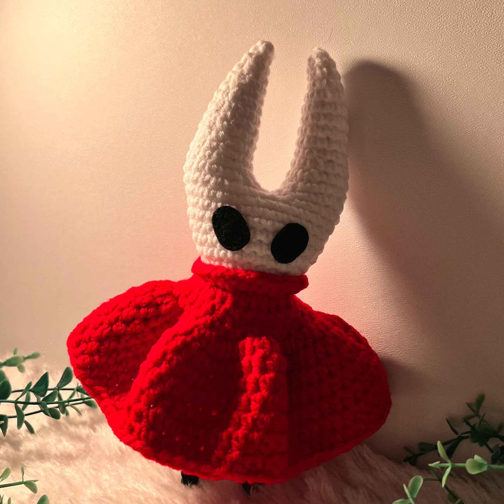 Close-up of the Hornet Crochet Doll, showing the fine stitching and handmade quality of the mask and cloak.