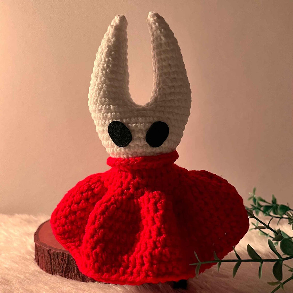 Close-up of the Hornet Crochet Doll, showing the fine stitching and handmade quality of the mask and cloak.