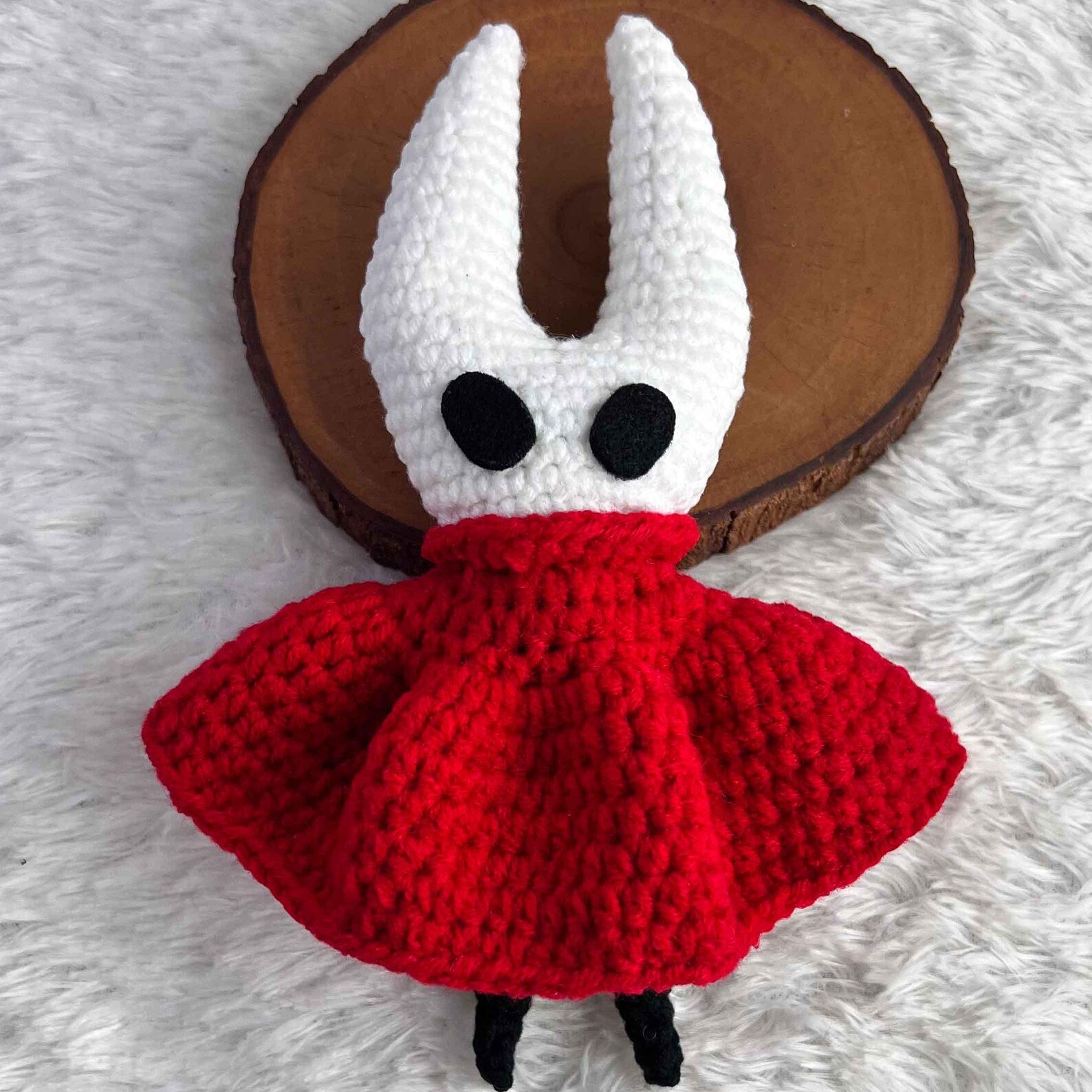 The Hornet Crochet Doll displayed in a cozy setting, emphasizing the warmth and charm of this handmade Silksong Merch.