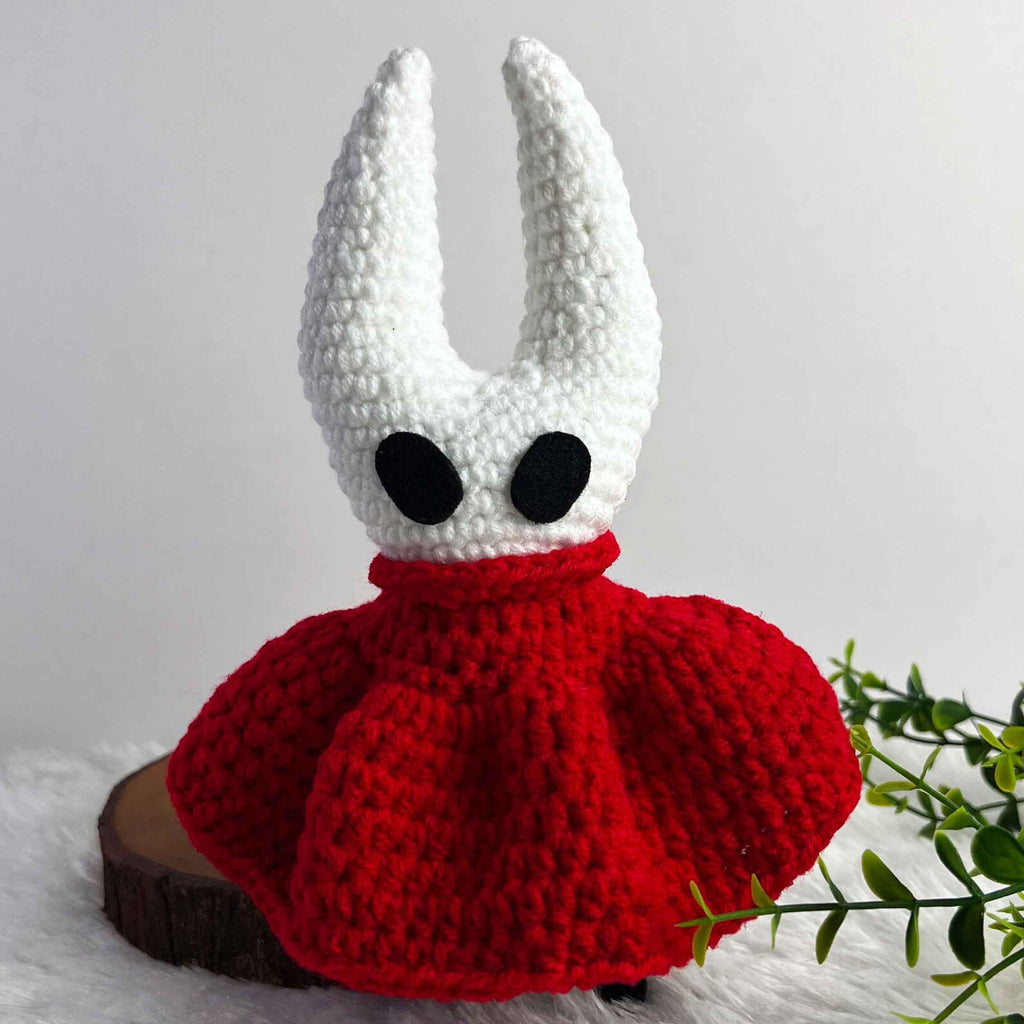 The Hornet Crochet Doll displayed in a cozy setting, emphasizing the warmth and charm of this handmade Silksong Merch.