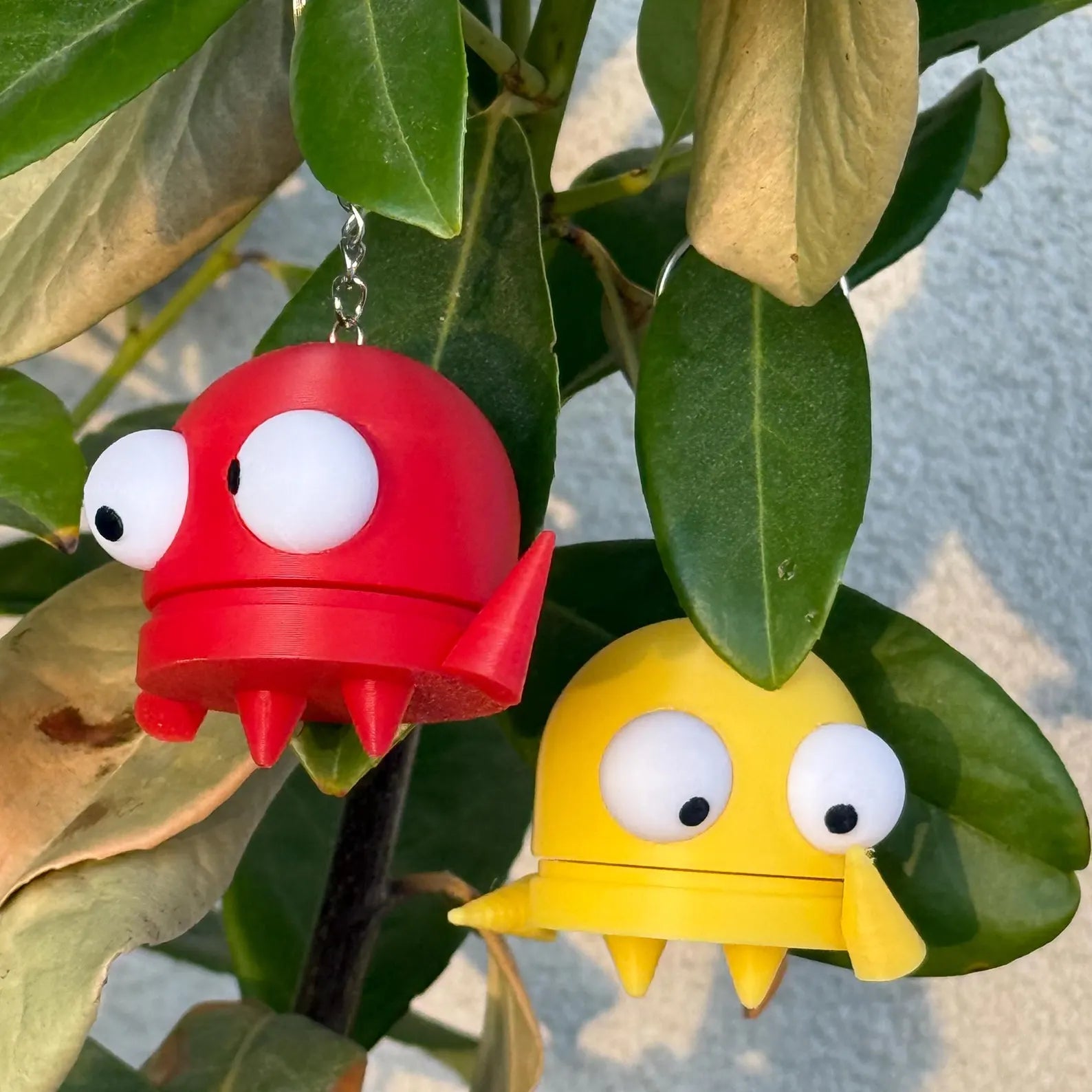 Red and yellow R.E.P.O. monsters hanging from a plant