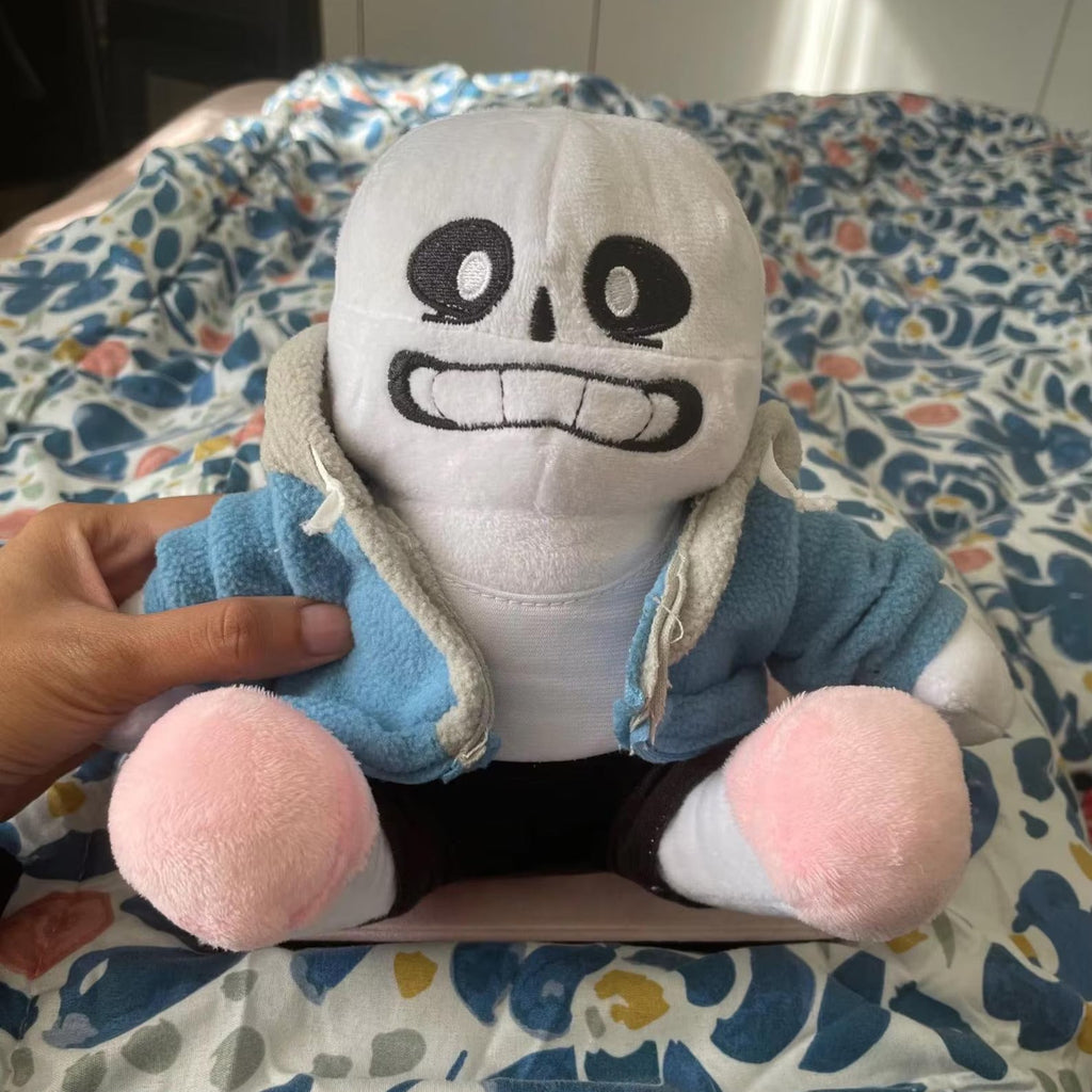 Undertale Sans Plush Toy is holding by someone's hand to show the real size