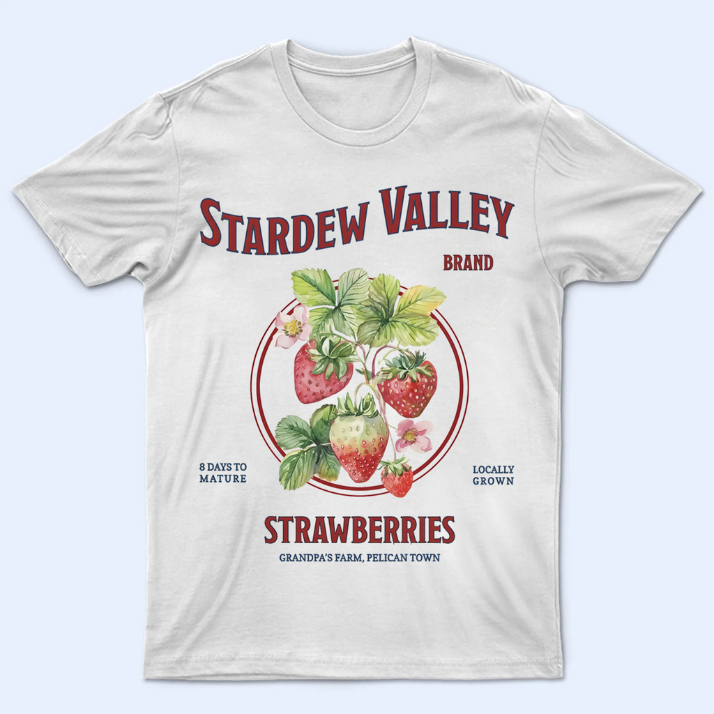 Front view of a Stardew Valley Strawberry T-Shirt featuring Grandpa's Farm and Pelican Town text