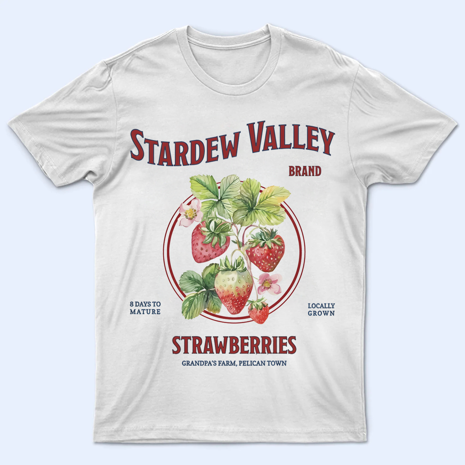 Front view of a Stardew Valley Strawberry T-Shirt featuring Grandpa's Farm and Pelican Town text