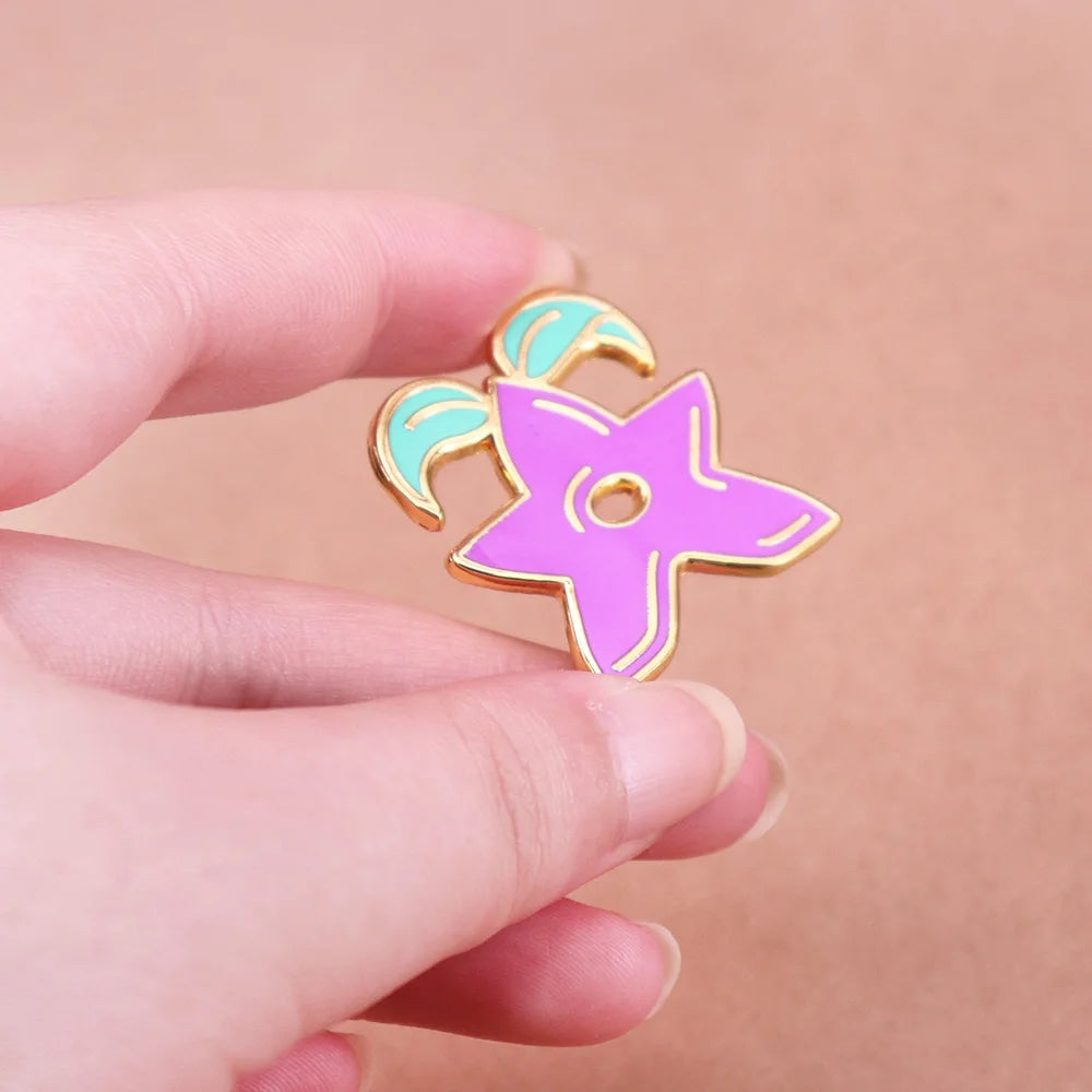 Close-up view of the Stardrop Enamel Pin, showing the smooth enamel and vibrant colors