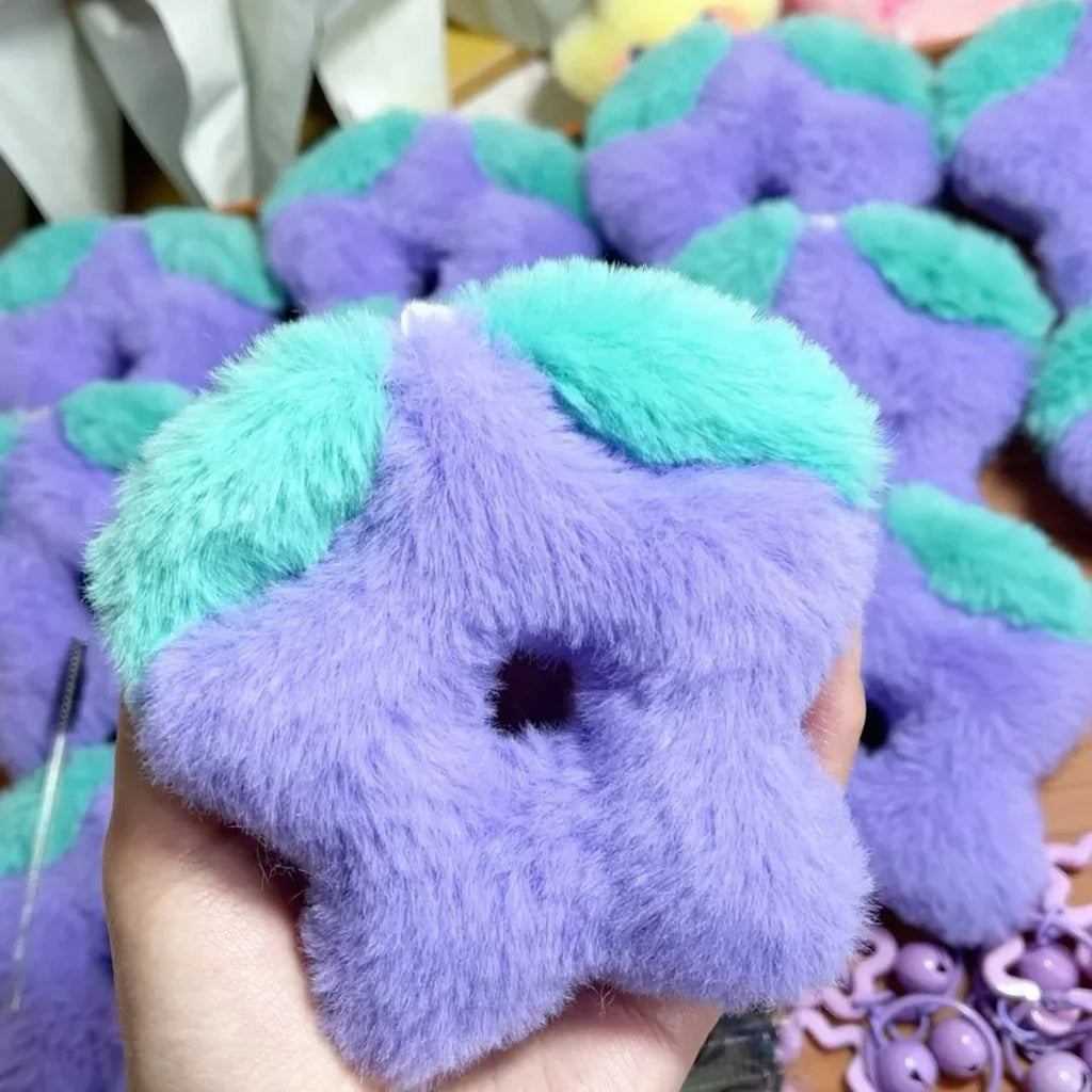Close-up view of the Stardrop Plush Keychain, showing the super soft material and vibrant purple color