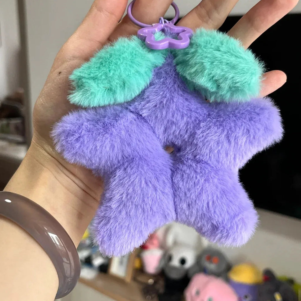 Close-up view of the Stardrop Plush Keychain, showing the super soft material and vibrant purple color