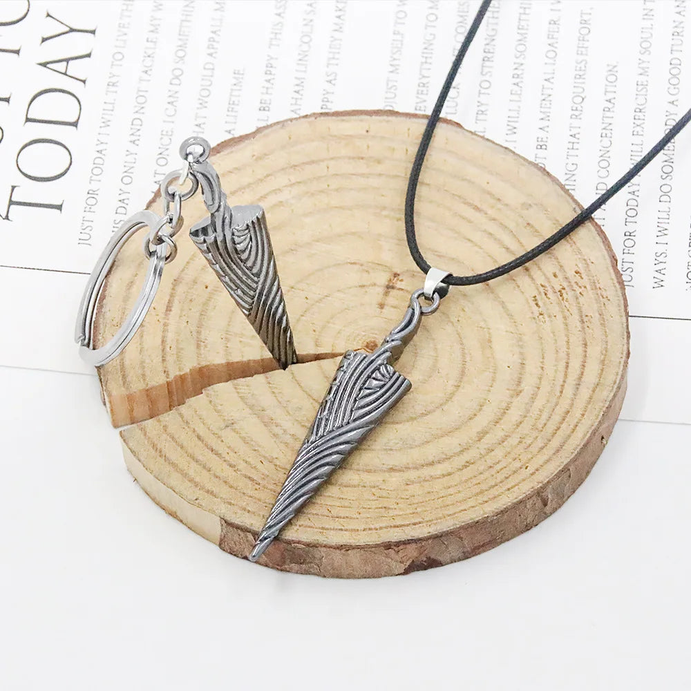 Hollow Knight Bone Nail pendant displayed on a wood slice