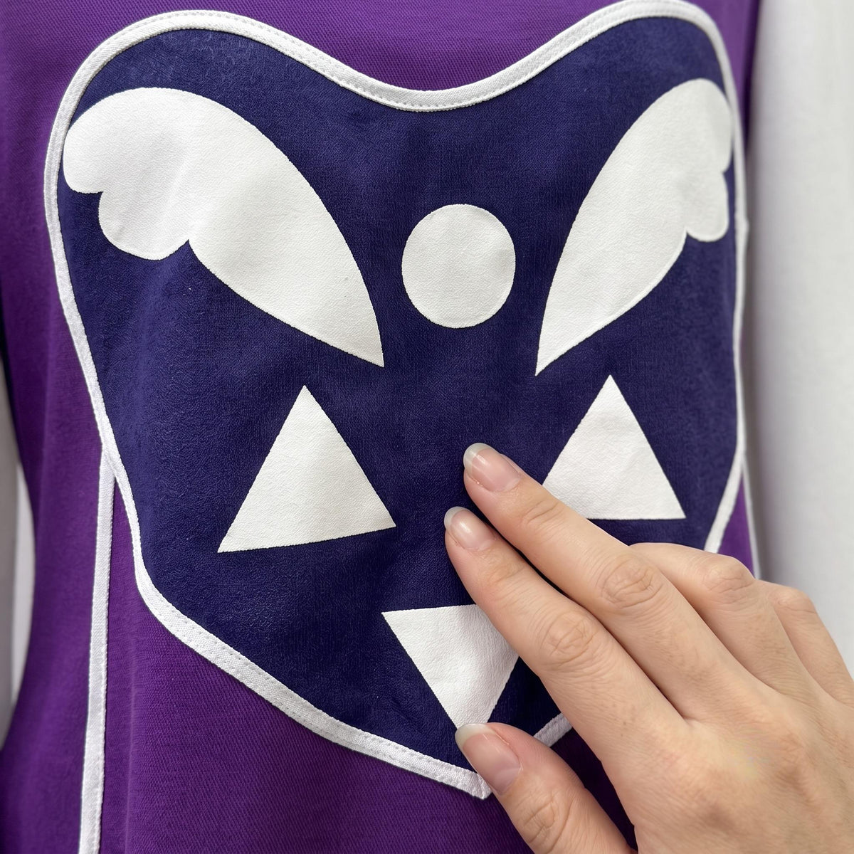 Close-up of the woven polyester material and neckline stitching on the Toriel Cosplay Costume.