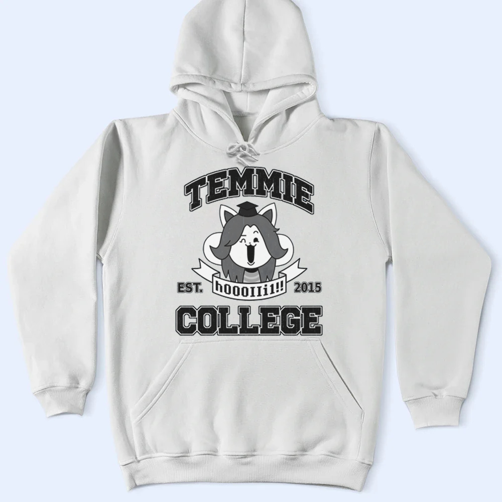 White hoodie with black graphics of Temmie and text on a light blue background