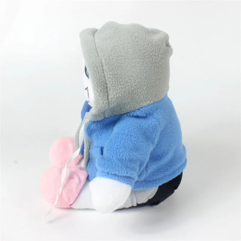 Side view of the Undertale Sans plush toy, showcasing his iconic skeleton grin and blue hoodie.