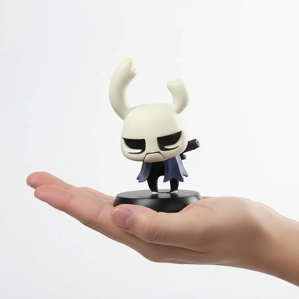 Small Zote figurine held in a hand against a white background